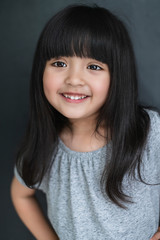 happiness black hair asian big eye girl portrait photo shoot with casual dress with fun on black screen background