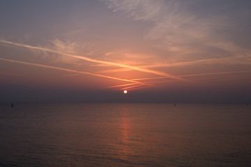 Naklejka premium sunrise over the sea,jet trails,horizon,panorama,view,water,seaside,light,cloud,nature,beautiful