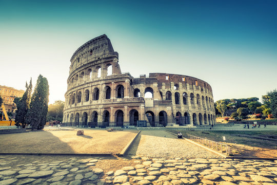 Fototapeta Colosseum in Rome, Italy, at sunrise. Colourful travel background.