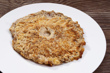 Fried parasol   mushroom fried mushroom on a white plate. Macrolepiota procera. © Oksana