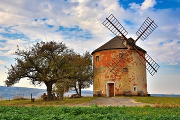 Fototapeta na wymiar Beautiful old windmill in autumn time. Landscape photo with architecture at sunset (golden hour). Kunkovice - Czech Republic - Europe.