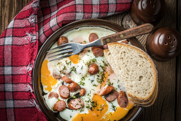 Tasty cooked egg with chopped sausages.