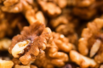 Background of unpeeled tasty walnuts close up