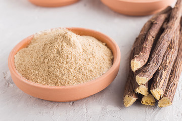 Powder and licorice root on the table - Glycyrrhiza glabra