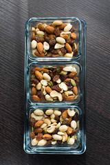 Raisins, peanuts and pistachio in elegant glass bowls