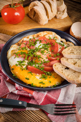 Homemade breakfast fried egg with tomato.