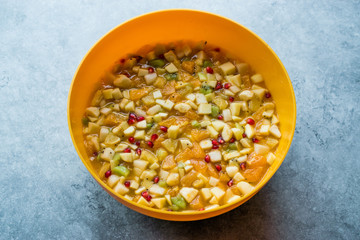 Homemade Healthy Organic Fruit Salad in Yellow Plastic Bowl.