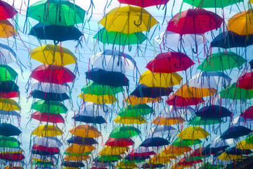 Fototapeta na wymiar The sky of colorful umbrellas. Street with umbrellas.Umbrella Sky.