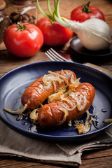 Fried sausage with onions.