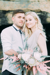Wedding ceremony in the mountains in nature. Decor in the style of fine art. Summer stylized photo shoot