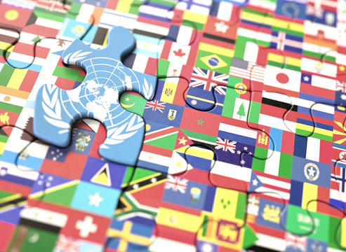 Concept puzzle with several flags of the world and United Nations in highlighted piece.