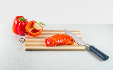 Bulgarian pepper on a cutting Board with a knife.