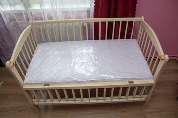 Fototapeta na wymiar crib in the room,a crib bought, a new crib in the home interior