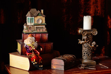 Christmas composition of books, a chest with keys, candles on a