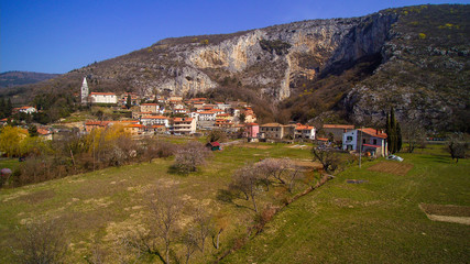 Fototapeta premium The Osp (Ospo) is a village close to Trieste just below a huge rock face of a steephead valley in western Slovenia. The place is well known for its rock walls, which offer free climbing all year long.