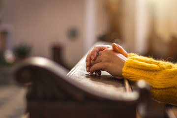 Female hands during prayer meditation in church