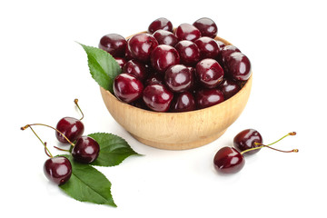 ripe juicy cherry berries with leaves in a plate