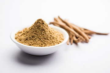 Ashwagandha / Aswaganda OR Indian Ginseng is an Ayurveda medicine in stem and powder form. Isolated on plain background. selective focus