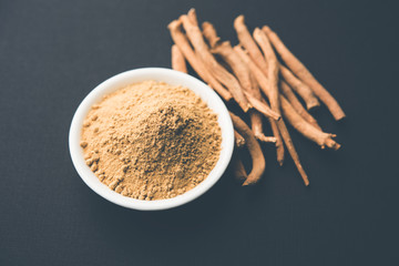 Ashwagandha / Aswaganda OR Indian Ginseng is an Ayurveda medicine in stem and powder form. Isolated on plain background. selective focus
