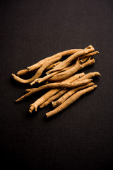 Ashwagandha / Aswaganda OR Indian Ginseng is an Ayurveda medicine in stem and powder form. Isolated on plain background. selective focus