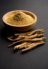Ashwagandha / Aswaganda OR Indian Ginseng is an Ayurveda medicine in stem and powder form. Isolated on plain background. selective focus