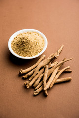 Ashwagandha / Aswaganda OR Indian Ginseng is an Ayurveda medicine in stem and powder form. Isolated on plain background. selective focus