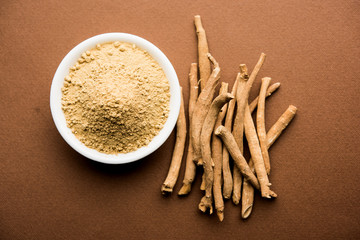 Ashwagandha / Aswaganda OR Indian Ginseng is an Ayurveda medicine in stem and powder form. Isolated on plain background. selective focus