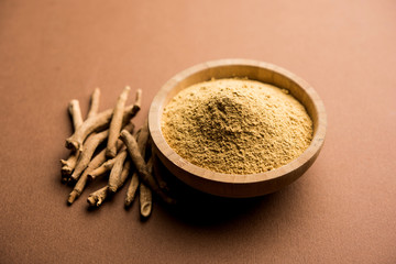 Ashwagandha / Aswaganda OR Indian Ginseng is an Ayurveda medicine in stem and powder form. Isolated on plain background. selective focus