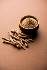 Ashwagandha / Aswaganda OR Indian Ginseng is an Ayurveda medicine in stem and powder form. Isolated on plain background. selective focus