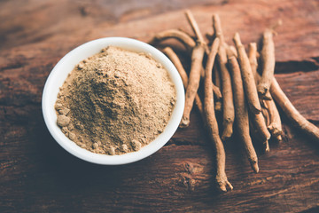 Ashwagandha / Aswaganda OR Indian Ginseng is an Ayurveda medicine in stem and powder form. Isolated on plain background. selective focus