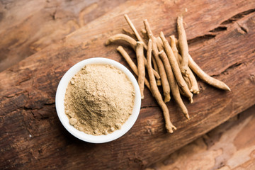 Ashwagandha / Aswaganda OR Indian Ginseng is an Ayurveda medicine in stem and powder form. Isolated on plain background. selective focus