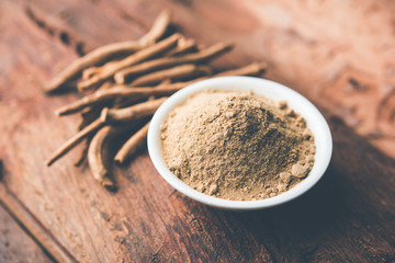 Ashwagandha / Aswaganda OR Indian Ginseng is an Ayurveda medicine in stem and powder form. Isolated on plain background. selective focus