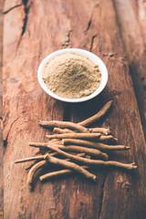 Ashwagandha / Aswaganda OR Indian Ginseng is an Ayurveda medicine in stem and powder form. Isolated on plain background. selective focus
