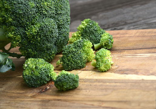 Powerful antioxidant of broccoli stands out as the most concentrated source of vitamin C..Broccoli on wooden floor.