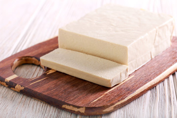Tofu cheese, sliced on wooden board