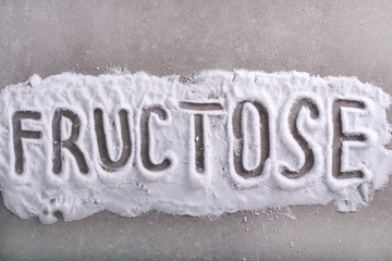 Fructose word written in fructose powder - obrazy, fototapety, plakaty