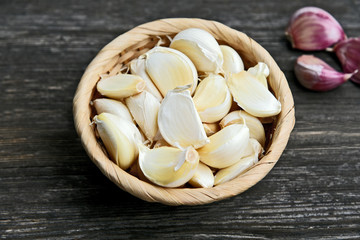 Garlic in basket on wooden back..Healthy and benefits of Garlic.