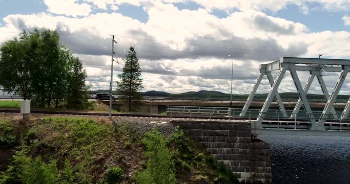 Flying on the side of the steel railroad bridge on a summer day at Kemijärvi Finland