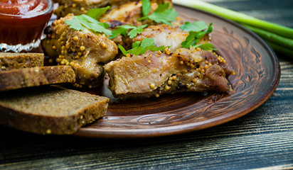 Delicious fried ribs, dressed with honey sauce, decorated with greens and vegetables.