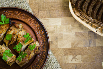 Delicious fried ribs, dressed with honey sauce, decorated with greens and vegetables.