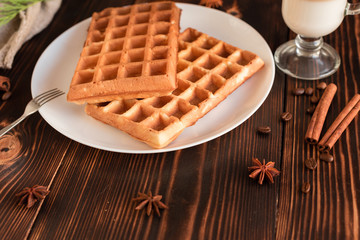 Tasty fresh Vienna wafers, jam and cup of coffee on a dark wooden background
