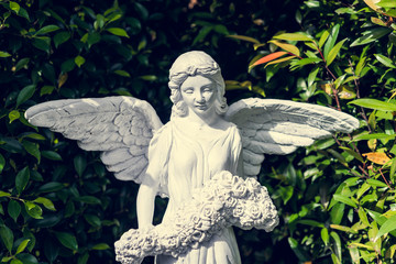 Beautiful ange statue in green garden, valentine romantic day - vintage tone