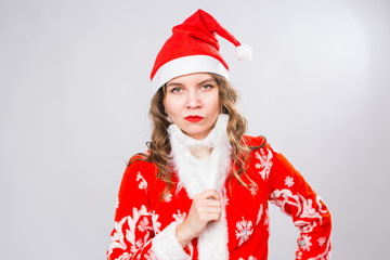 Christmas, emotions and joke concept - woman in santa costume with fake beard look at you seriously and angrily on white background with copy space