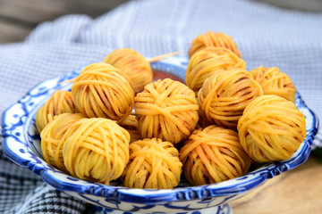 Deep Fried Wrapped Pork with Noodle Thai traditional snacks menu ( Thai name is Moo sarong) in Thai style bowl with cucumber salad and sweet chili sauce.