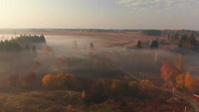 Flight in early foggy morning outside the city in Russia