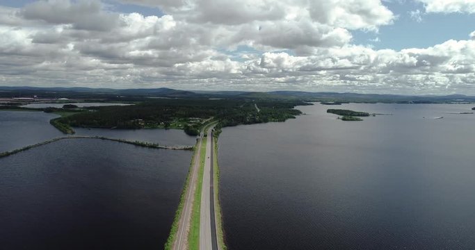 Narrow road with light traffic between two lakes, seen from the air, Kemijärvi Finland