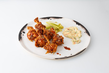 fried chicken legs with salad isolated on white background