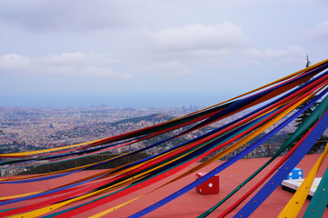 Multicolored ribbons on the viewing platform Tibidabo, cityscape of Barcelona, Spain