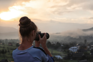 Professional nature photographer taking photos in mountains