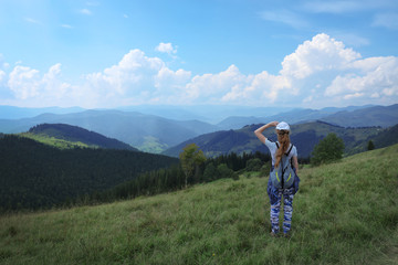 Fototapeta na wymiar Woman with backpack in wilderness. Mountain landscape